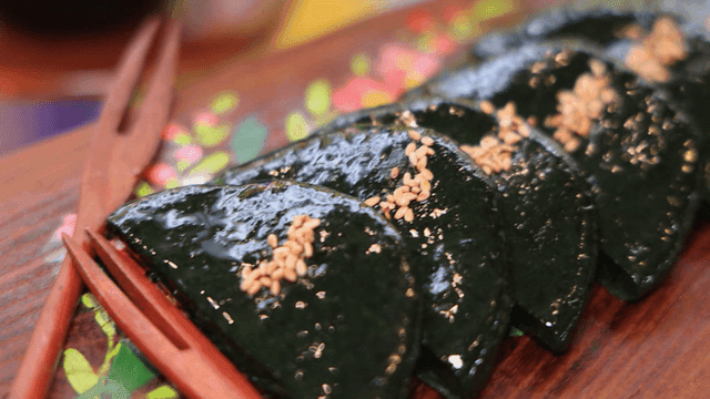 Glossy mugwort rice cakes sprinkled with sesame seeds