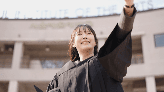 Graduates waving their hands and greeting each other