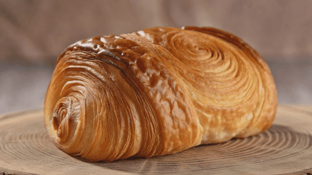 Freshly baked pain au chocolat on wooden board