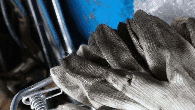 금속 장비 위의 낡은 작업 장갑