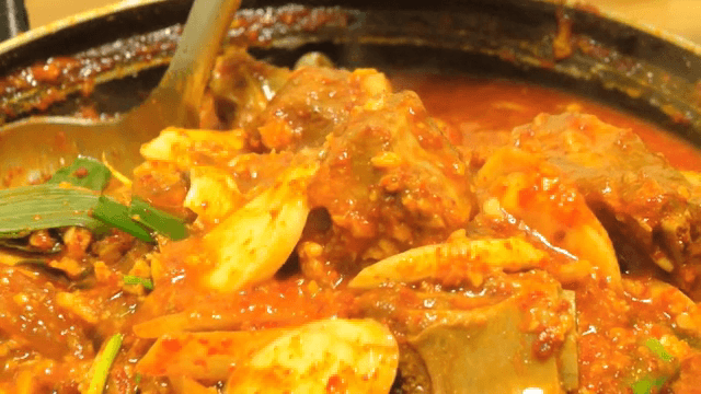 Spicy Braised Pork Galbi boiling in a pot