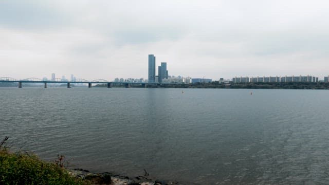 Overcast Day Overlooking a Calm River and Cityscape