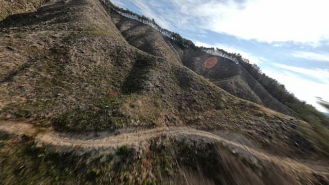 Expansive mountainous landscape with forested valleys in daytime