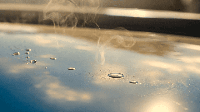 Steam rising from water droplets