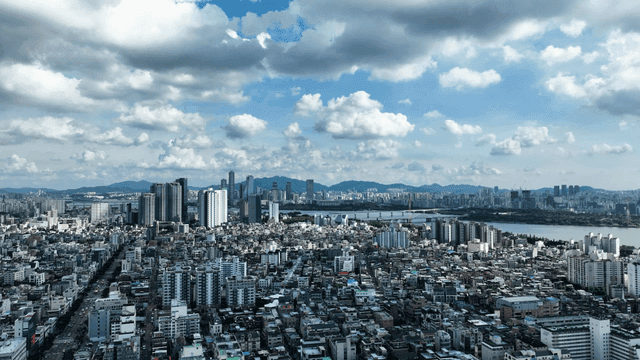 City landscape spread out beneath cloudy sky