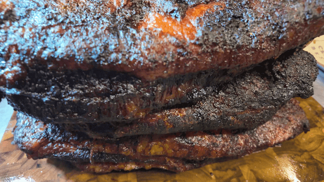 Juicy smoked brisket on a wooden board