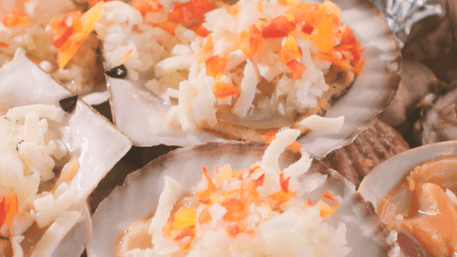 Cheese and vegetables on grilled scallops