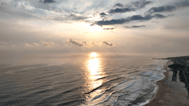 Sunset over a tranquil ocean with waves