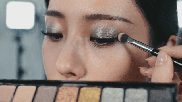 Woman applying eyeshadow with brush