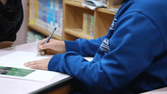 Elementary school students writing in classroom