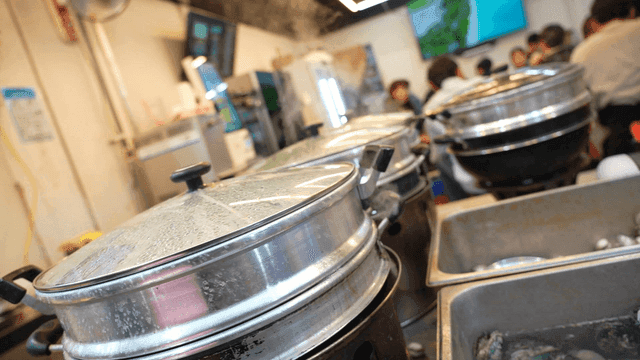 Steaming pots in a busy kitchen