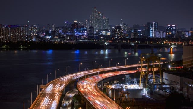 Night cityscape with bustling highways and flowing traffic