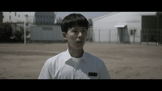 Student standing in a schoolyard