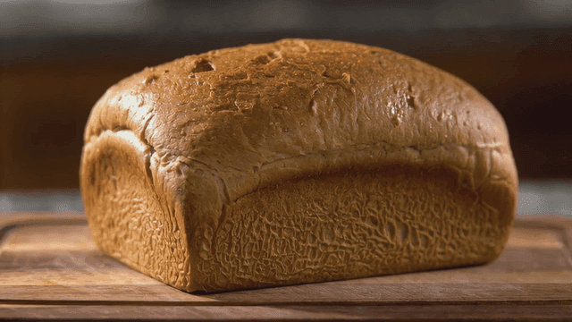 Freshly baked loaf of bread on a wooden board