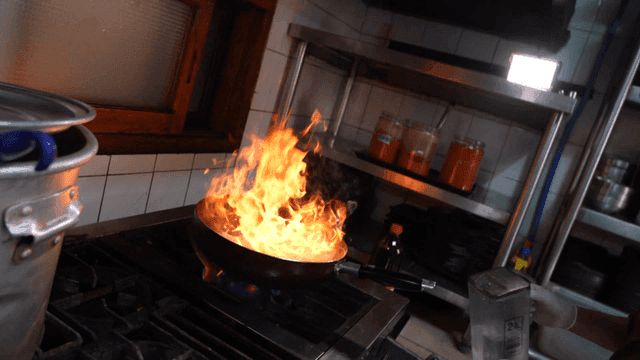 Flames rising from fan on stove
