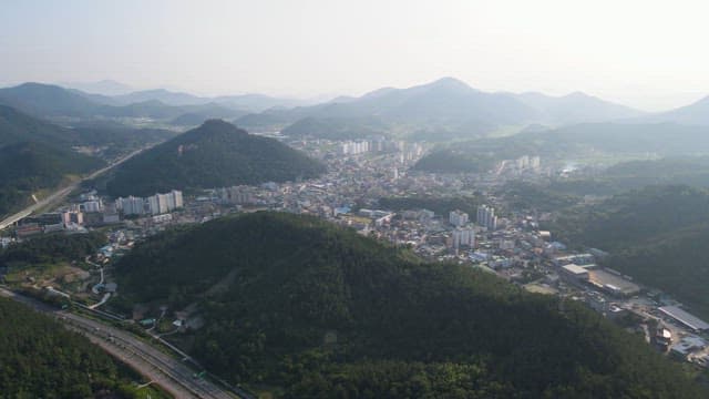 City surrounded by lush green hills