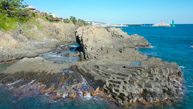 Rocky coast on a sunny day with columnar joint