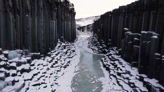 Snow-covered canyon with frozen river