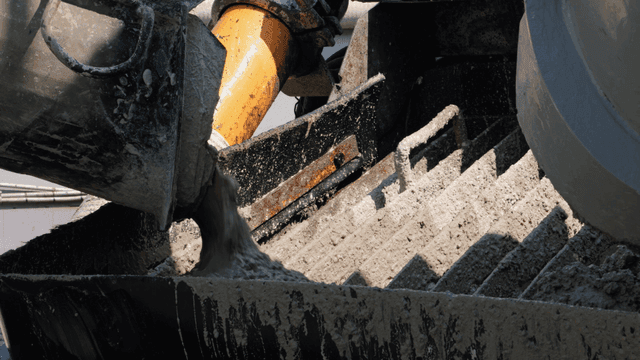 Concrete being poured into a mixer