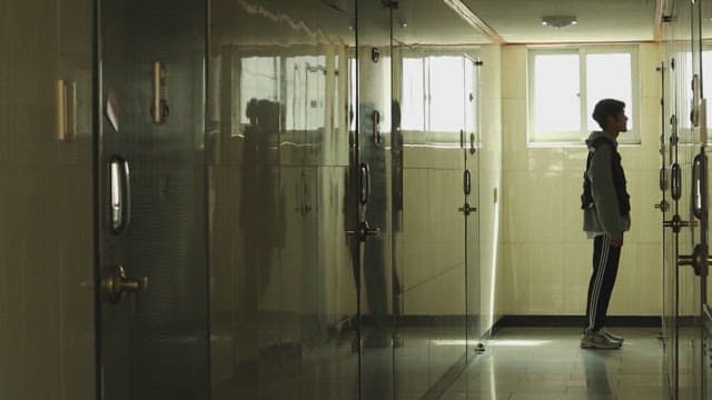 어두운 복도에서 고개를 숙이는 사람