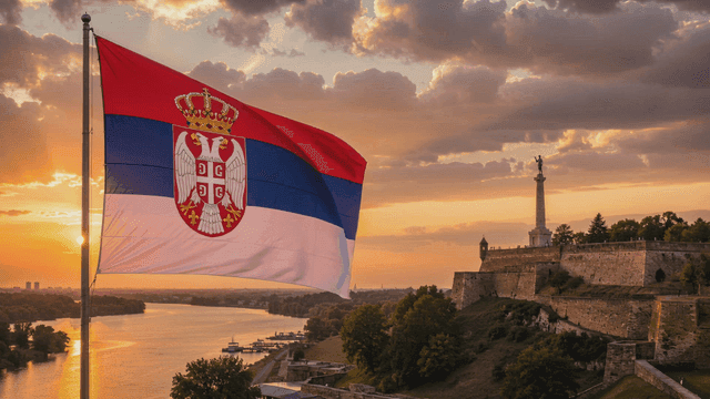 Serbian flag waving near a historic fortress