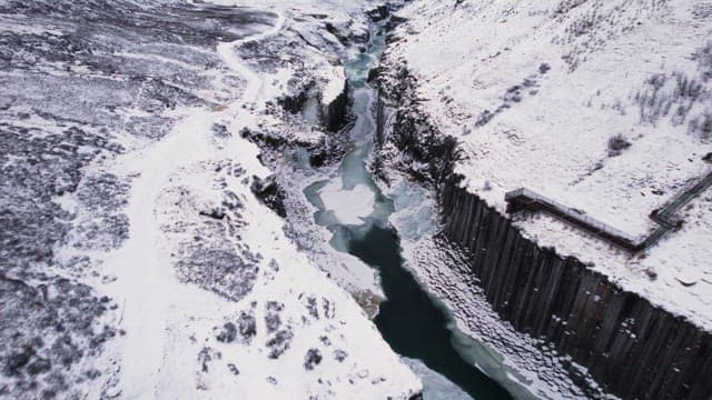 Snow-covered canyon with a frozen river