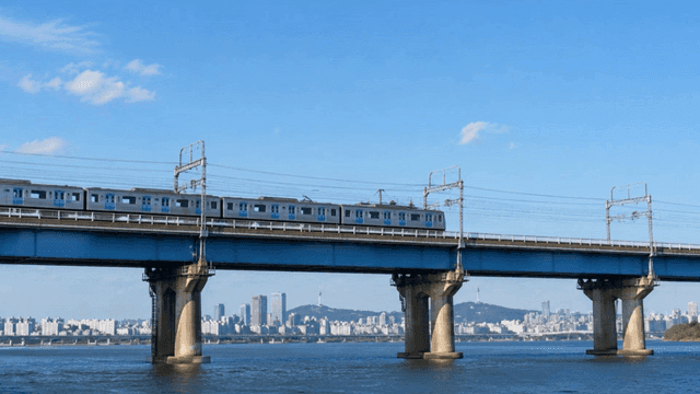 Train crossing a bridge over a river