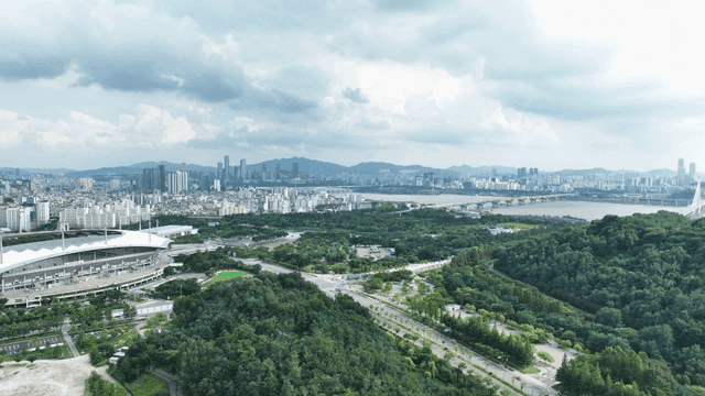 Vast city landscape with stadium and river