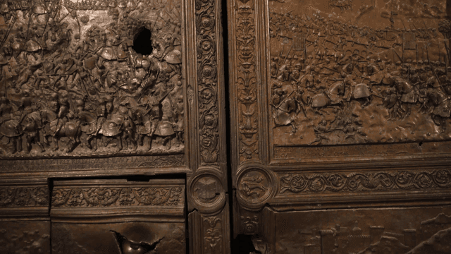Intricate carvings on a large bronze door