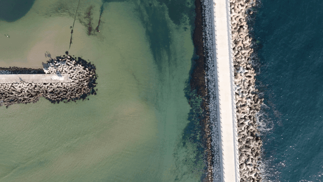 Aerial view of a pier and clear sea