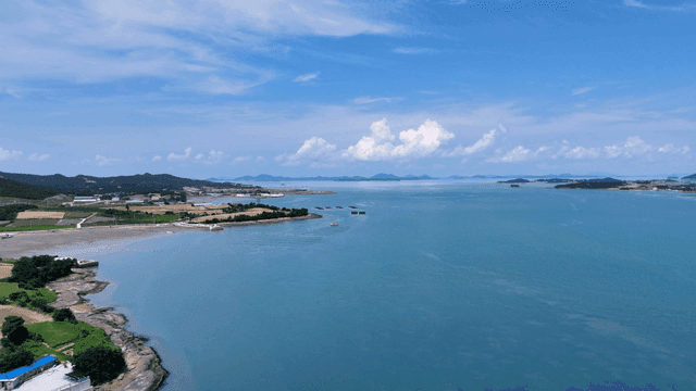 Coastal village with wide ocean view.