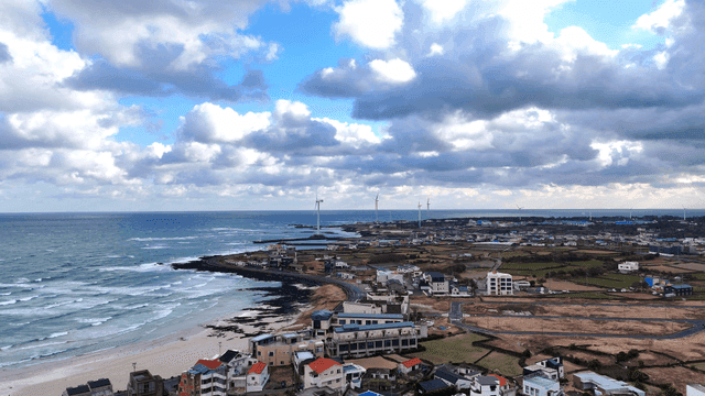 Coastal rural area with sea and wind turbines