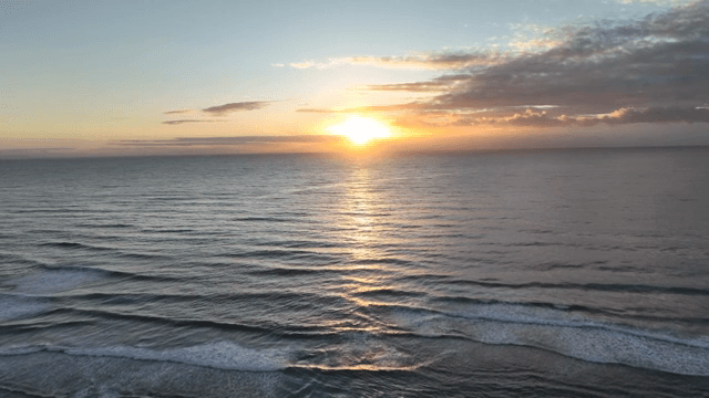 Sunset over a calm ocean horizon