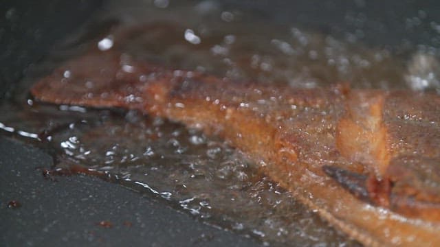 Fish being fried in hot oil