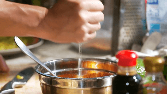 Squeezing lemon juice into a metal bowl