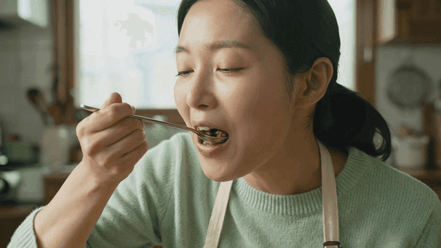 Woman eating bok choy bibimbap with spoon