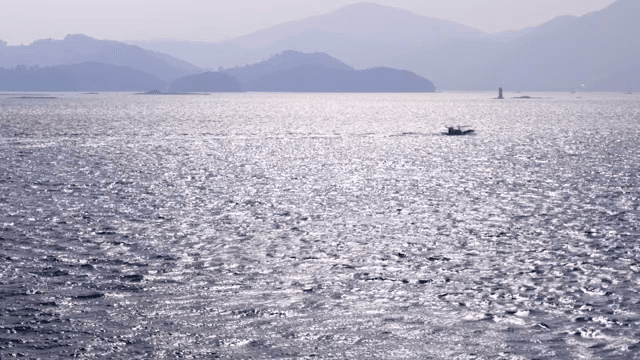Boat sailing on a shimmering sea