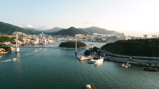 Coastal Cityscape with Bridge and Boats