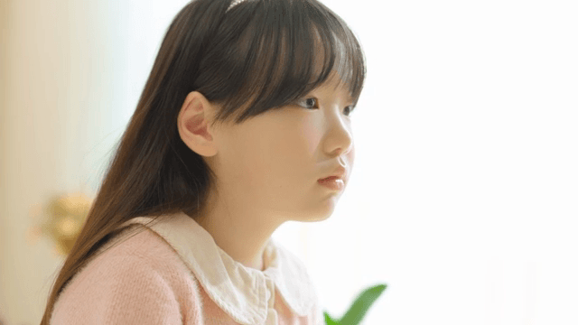 Young girl looking thoughtfully indoors