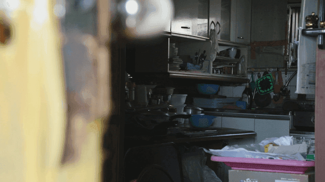 Cluttered kitchen with various utensils