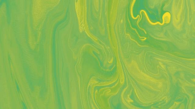 Abstract pattern of green and yellow liquids mixing together