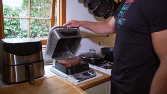 Man Preparing Meat in Kitchen
