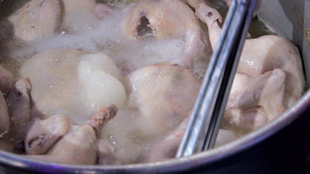 Putting cooked chicken on a large tray