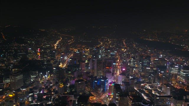 Colorful Urban Night View with Illuminated Buildings and Road Lights