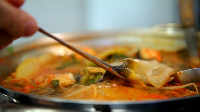 Puffer fish slices of kimchi stew boiling in a pot