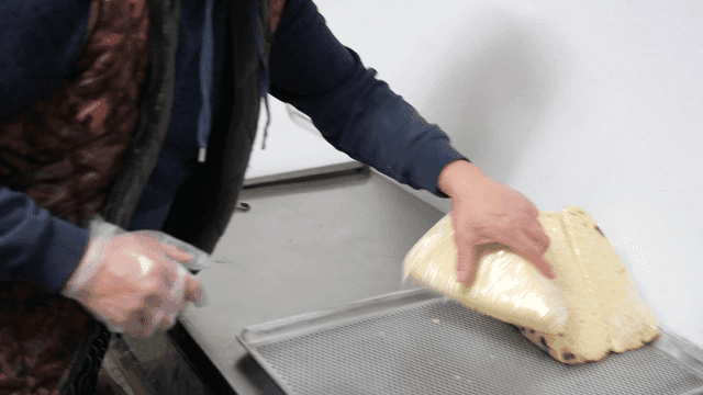 Sight of makgeolli steamed bread being wrapped in plastic.