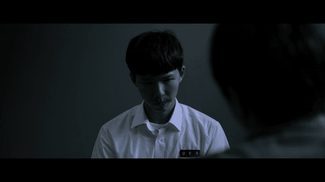 Male student being interrogated in dark room