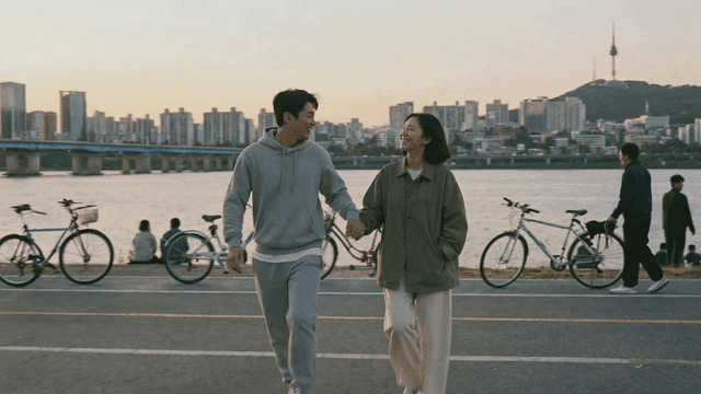Couple walking in city riverside park