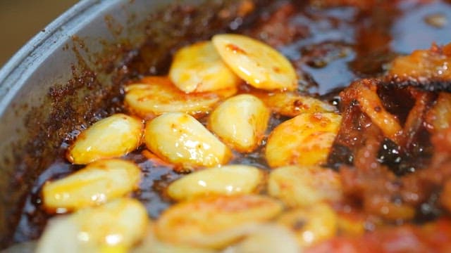 Garlic, kimchi and bean sprouts sizzling in a pan