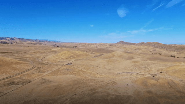Vast desert landscape under clear blue sky